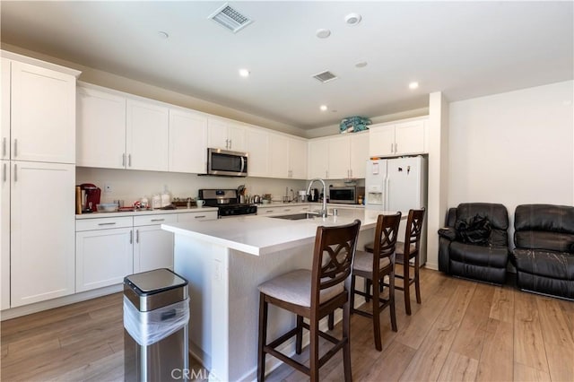 956 W Clover Ave, Rialto, CA 92376 - kitchen featuring appliances with stainless steel finishes, light wood-style floors, white cabinetry, and recessed lighting