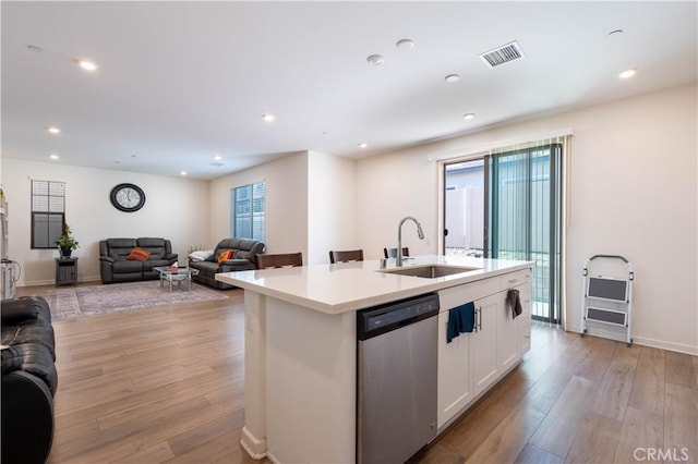 956 W Clover Ave, Rialto, CA 92376 - kitchen with dishwasher, a sink, open floor plan, white cabinets, and light wood-style floors