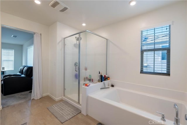 956 W Clover Ave, Rialto, CA 92376 - bathroom featuring connected bathroom, a garden tub, healthy amount of natural light, a shower stall, and recessed lighting