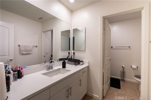 956 W Clover Ave, Rialto, CA 92376 - bathroom featuring toilet, vanity, tile patterned flooring, and baseboards