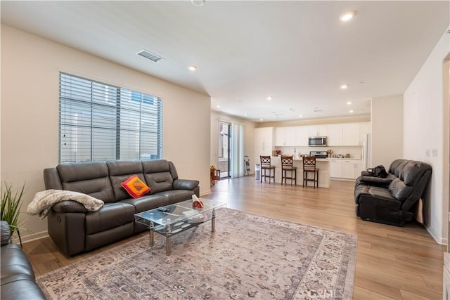 956 W Clover Ave, Rialto, CA 92376 - living room with light wood finished floors, recessed lighting, and baseboards