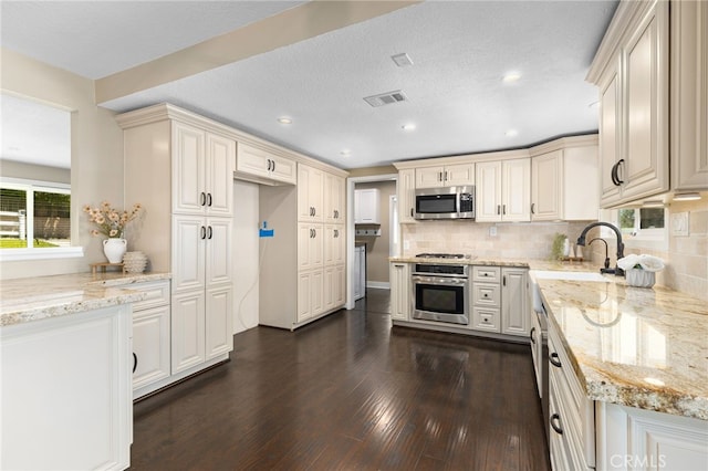 8729 Hillside Rd, Rancho Cucamonga, CA 91701 - kitchen with stainless steel appliances, a sink, dark wood-style floors, plenty of natural light, and recessed lighting