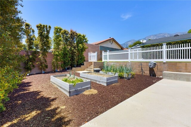 8729 Hillside Rd, Rancho Cucamonga, CA 91701 - fenced backyard with a vegetable garden and a mountain view