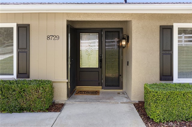 8729 Hillside Rd, Rancho Cucamonga, CA 91701 - view of exterior entry featuring stucco siding and metal roof
