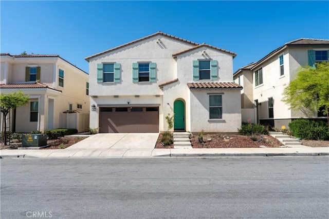 980 W Jasmine Way, Rialto, CA 92376 - mediterranean / spanish house featuring a tile roof, stucco siding, driveway, and an attached garage