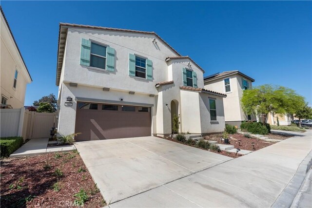980 W Jasmine Way, Rialto, CA 92376 - mediterranean / spanish home featuring a garage, stucco siding, concrete driveway, and a tile roof