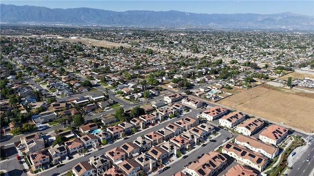 980 W Jasmine Way, Rialto, CA 92376 - aerial view of property and surrounding area featuring a mountainous background and nearby suburban area