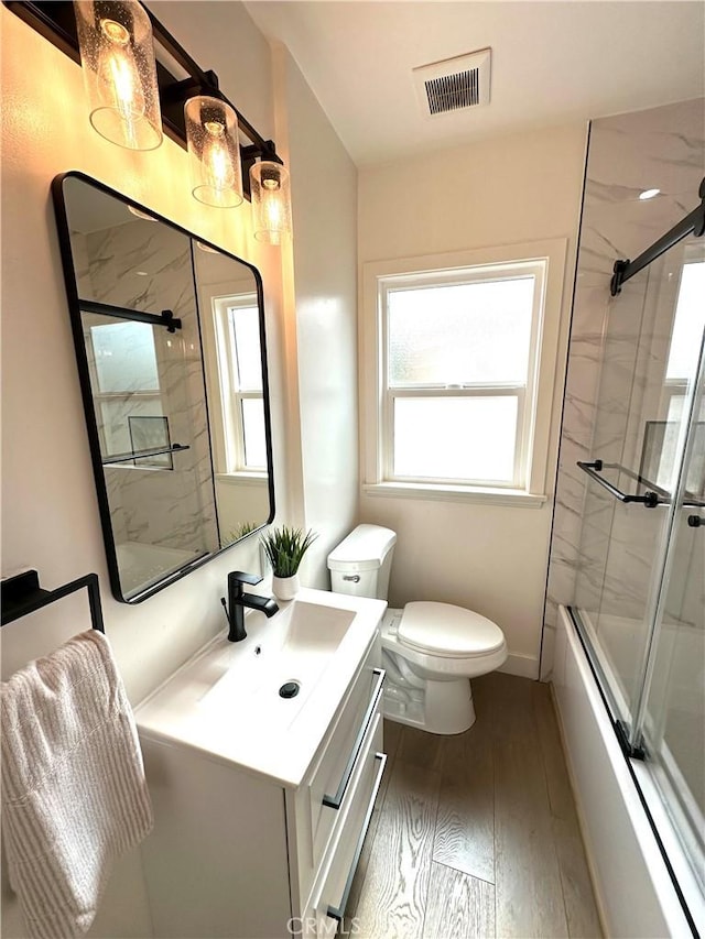 16913 Covello St, Van Nuys, CA 91406 - bathroom featuring vanity, shower / bath combination with glass door, and wood finished floors