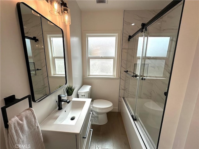 16913 Covello St, Van Nuys, CA 91406 - bathroom featuring wood finished floors, vanity, and shower / bath combination with glass door