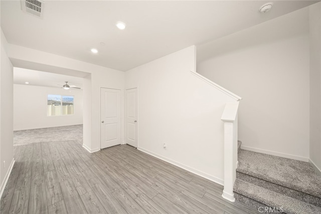 42499 Aruba Ct, Indio, CA 92201 - empty room featuring a smoke detector, baseboards, wood finished floors, stairway, and recessed lighting