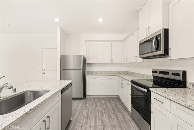 42499 Aruba Ct, Indio, CA 92201 - kitchen with appliances with stainless steel finishes, a sink, white cabinets, and recessed lighting