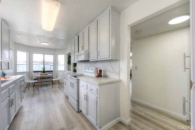 14 Fernwood Ct, Pittsburg, CA 94565 - kitchen featuring white appliances, light countertops, light wood-type flooring, and white cabinetry