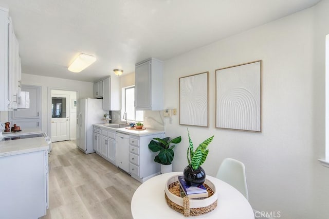 14 Fernwood Ct, Pittsburg, CA 94565 - kitchen featuring white appliances, a sink, light countertops, and light wood-style floors
