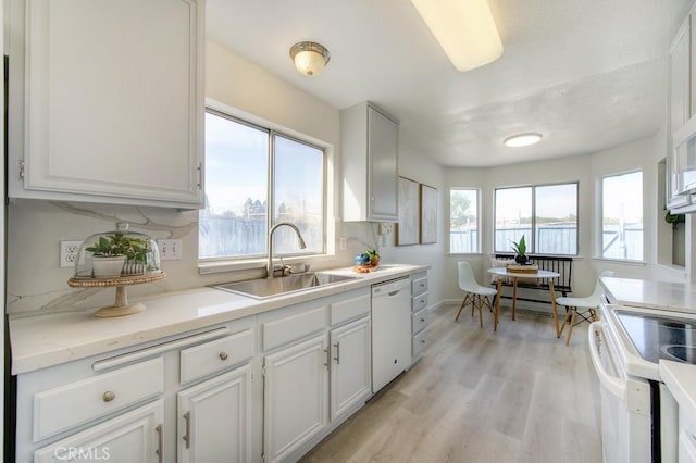 14 Fernwood Ct, Pittsburg, CA 94565 - kitchen with white appliances, a sink, light wood finished floors, light countertops, and white cabinetry