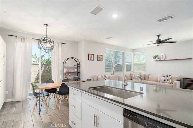 3611 Highclere Way, Clovis, CA 93619 - kitchen featuring a sink, stainless steel dishwasher, open floor plan, white cabinetry, and recessed lighting