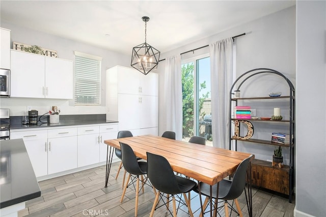 3611 Highclere Way, Clovis, CA 93619 - dining area with light wood-style flooring and a chandelier