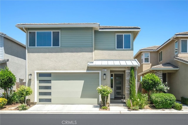 3611 Highclere Way, Clovis, CA 93619 - view of front facade featuring a standing seam roof, stucco siding, an attached garage, driveway, and metal roof