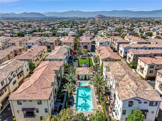 12473 Constellation St, Eastvale, CA 91752 - aerial perspective of suburban area with a pool and a mountainous background