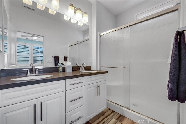 12473 Constellation St, Eastvale, CA 91752 - full bath with double vanity, a stall shower, and wood finished floors