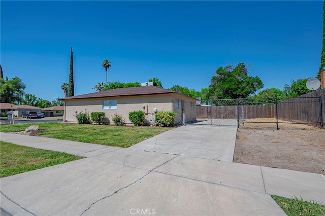 1615 Loughborough Dr, Merced, CA 95348 - view of side of home with stucco siding and driveway