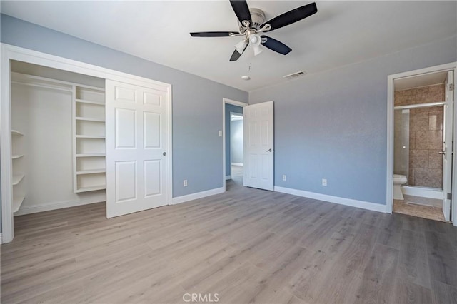 1615 Loughborough Dr, Merced, CA 95348 - unfurnished bedroom with baseboards, wood finished floors, a closet, and connected bathroom