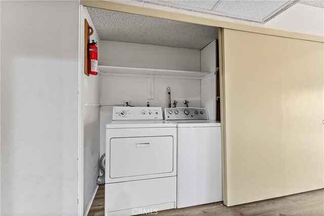 105 Tangelo Unit 400, Irvine, CA 92618 - laundry area featuring washer and clothes dryer and wood finished floors