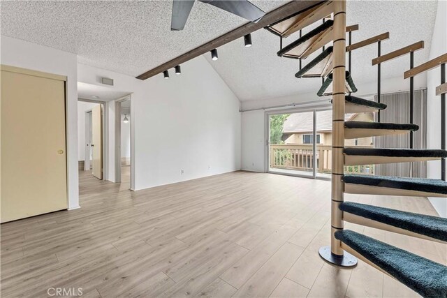 105 Tangelo Unit 400, Irvine, CA 92618 - unfurnished living room featuring stairs, a textured ceiling, wood finished floors, and a ceiling fan
