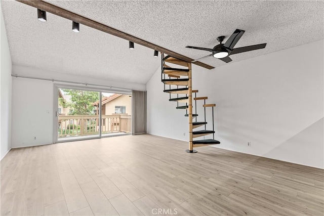 105 Tangelo Unit 400, Irvine, CA 92618 - unfurnished living room featuring a textured ceiling, a ceiling fan, lofted ceiling, wood finished floors, and stairs
