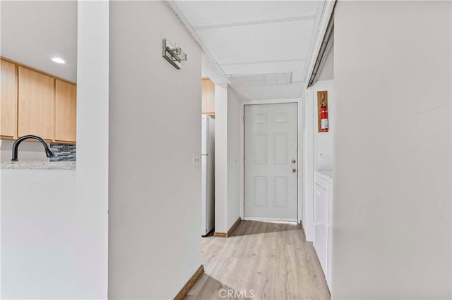 105 Tangelo Unit 400, Irvine, CA 92618 - corridor with a sink, light wood finished floors, baseboards, and recessed lighting