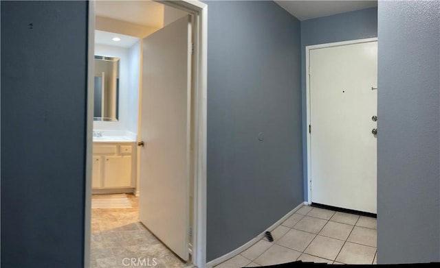 6815 Remmet Ave Unit 219, Canoga Park, CA 91303 - corridor with light tile patterned flooring and baseboards