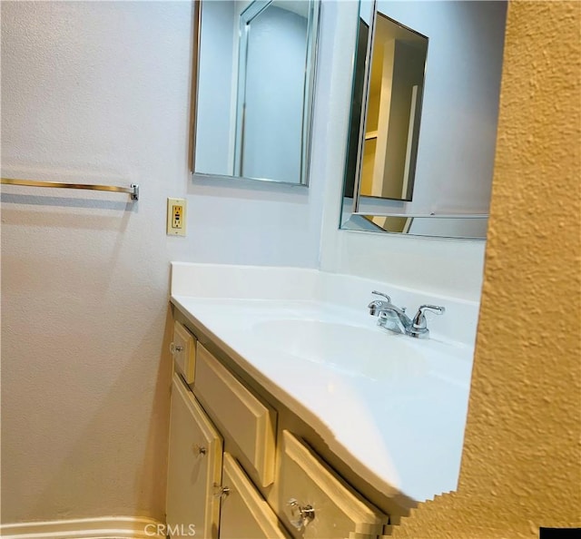 6815 Remmet Ave Unit 219, Canoga Park, CA 91303 - bathroom featuring vanity and a textured wall