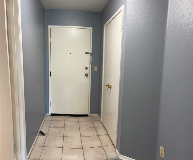 6815 Remmet Ave Unit 219, Canoga Park, CA 91303 - doorway to outside featuring light tile patterned floors and baseboards