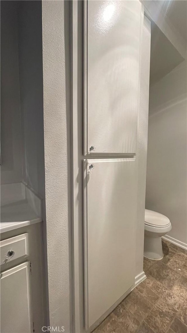 6815 Remmet Ave Unit 219, Canoga Park, CA 91303 - bathroom with toilet and stone finish floors