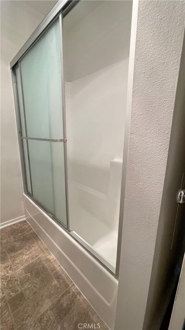 6815 Remmet Ave Unit 219, Canoga Park, CA 91303 - full bath featuring stone finish flooring and shower / bath combination with glass door