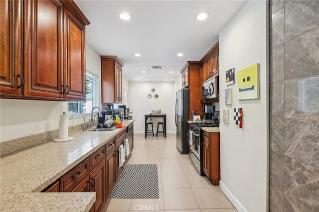 7117 Vanscoy Ave, North Hollywood, CA 91605 - kitchen featuring stainless steel appliances, a sink, light stone countertops, light tile patterned flooring, and recessed lighting