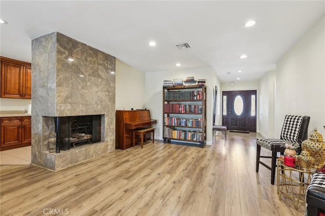 7117 Vanscoy Ave, North Hollywood, CA 91605 - living room featuring light wood-style floors, recessed lighting, a tile fireplace, and baseboards