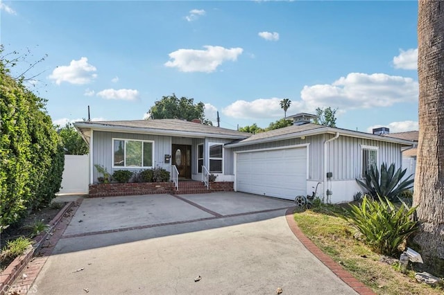 7117 Vanscoy Ave, North Hollywood, CA 91605 - ranch-style house featuring board and batten siding, driveway, and an attached garage