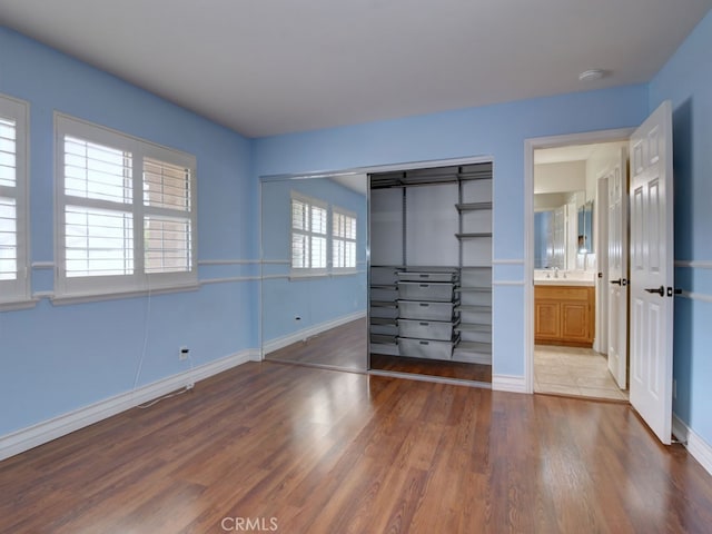 10655 Bruns Dr, Tustin, CA 92782 - unfurnished bedroom with wood finished floors, baseboards, a sink, and a closet