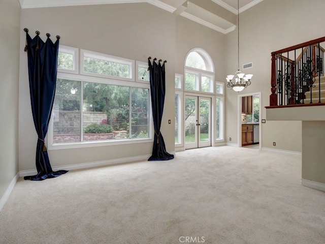 10655 Bruns Dr, Tustin, CA 92782 - unfurnished living room with carpet floors, a chandelier, baseboards, ornamental molding, and a towering ceiling