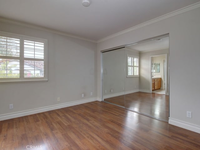 10655 Bruns Dr, Tustin, CA 92782 - unfurnished bedroom with wood finished floors, baseboards, ornamental molding, and a closet