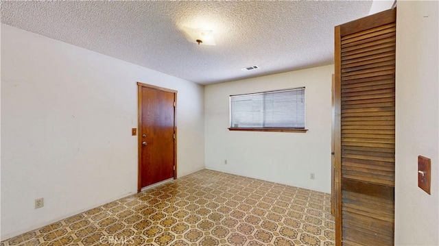 20061 Seneca Rd, Apple Valley, CA 92307 - spare room with a textured ceiling and tile patterned floors