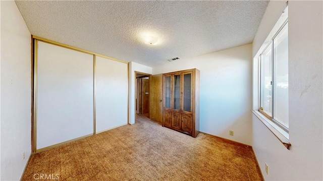 20061 Seneca Rd, Apple Valley, CA 92307 - unfurnished bedroom with carpet, a textured ceiling, and a closet