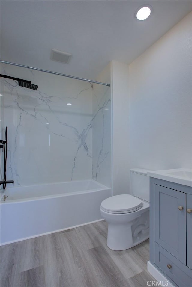 12337 W Main St, Turlock, CA 95380 - full bathroom featuring wood finished floors, toilet, vanity, and shower / washtub combination