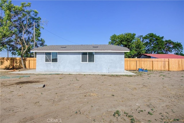 12337 W Main St, Turlock, CA 95380 - rear view of house featuring a fenced backyard and stucco siding
