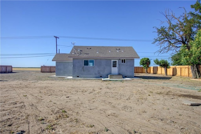 12337 W Main St, Turlock, CA 95380 - back of house featuring stucco siding, entry steps, and roof with shingles