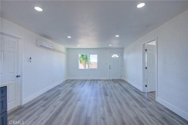 12337 W Main St, Turlock, CA 95380 - foyer entrance featuring a wall mounted air conditioner, baseboards, recessed lighting, and light wood finished floors