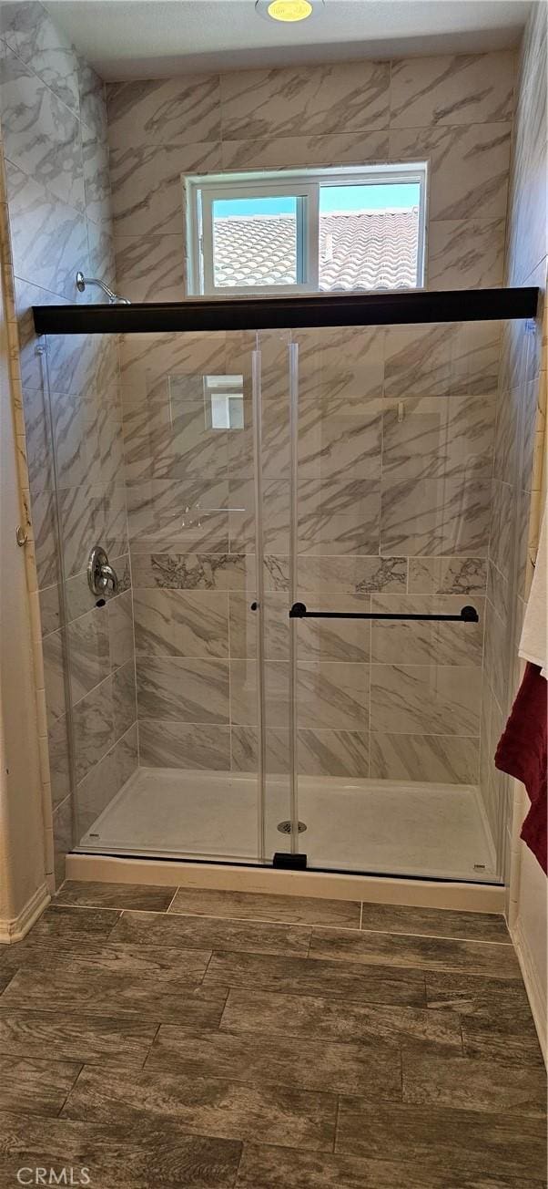 1536 Williamson, Beaumont, CA 92223 - bathroom with healthy amount of natural light, a shower stall, and wood finished floors