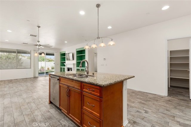 1536 Williamson, Beaumont, CA 92223 - kitchen with stainless steel dishwasher, a sink, open floor plan, a kitchen island with sink, and light wood-type flooring
