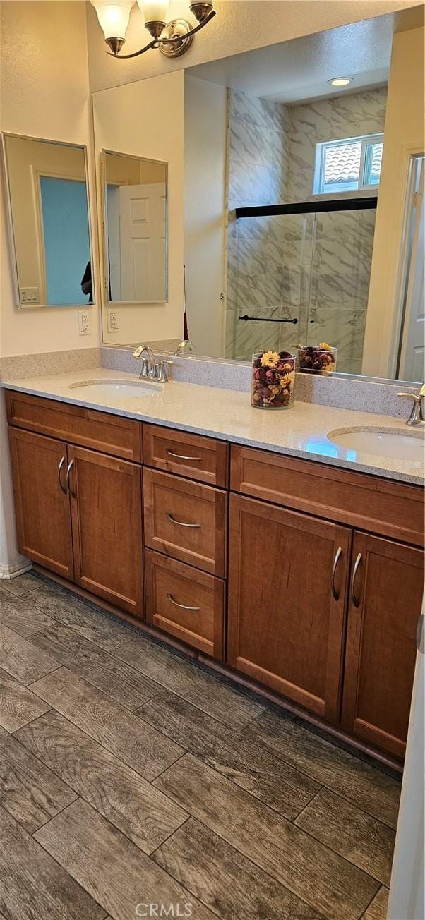 1536 Williamson, Beaumont, CA 92223 - bathroom with double vanity, wood finished floors, a shower with shower door, and a chandelier