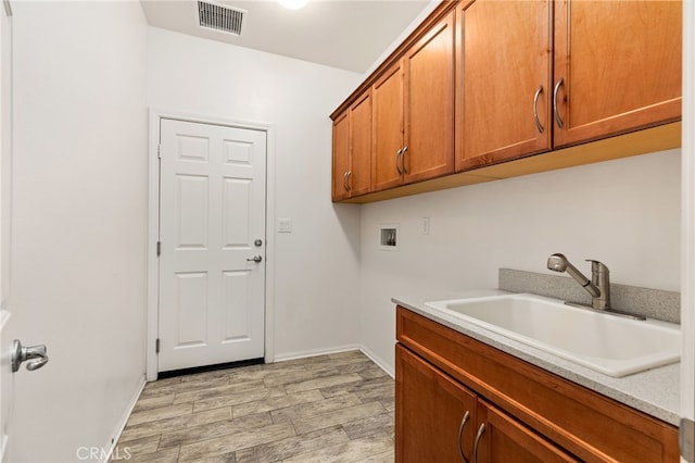 1536 Williamson, Beaumont, CA 92223 - laundry room featuring washer hookup, light wood-style flooring, cabinet space, and baseboards